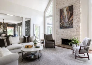 Elegant open-concept living room with vaulted ceilings, neutral tones, and modern furnishings.