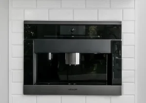 Close-up of built-in microwave with black trim and white subway tile backsplash in Princeton NJ kitchen remodel