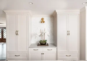 White oak built-in bar with paneled drawers, brass sconces, and custom shelving in Princeton, NJ