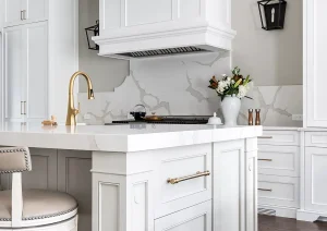 Elegant white kitchen island with decorative corbels and detailed cabinetry.