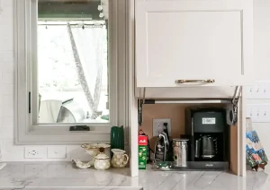 Small beverage station with floating shelves, white cabinetry, and brass sconce in Princeton, NJ remodel