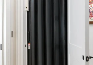 Contemporary black slatted interior door design in modern Newtown, PA remodel.