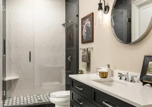 Modern black-and-white bathroom with patterned tile flooring and dark vanity cabinetry in Newtown, PA.