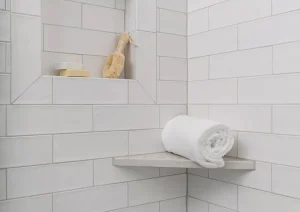 Built-in shower niche with marble shelf and white subway tile in luxury New Hope, PA bathroom remodel