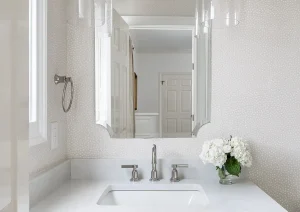 Bright white pedestal sink with chrome fixtures and classic wainscoting in New Hope, PA bathroom remodel