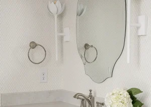 White vanity with scalloped mirror, quartz counter, and floral accent in New Hope, PA bathroom